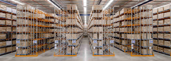 Numbered aisles of double deep pallet racking fully loaded with boxed inventory