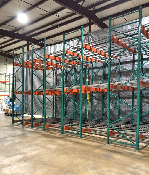 Pallet flow racking lanes with pallets resting on gravity rollers