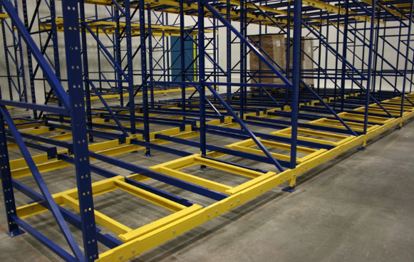 Push back racking bays with pallets nested on carts several positions deep