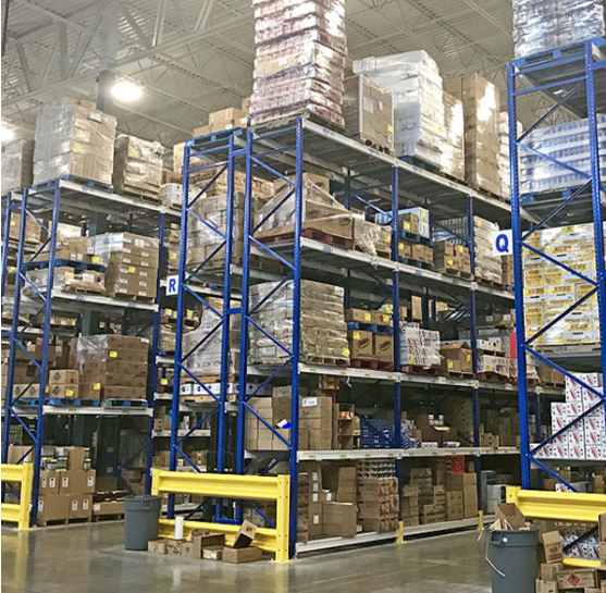 Forklift retrieving a pallet from selective pallet racking